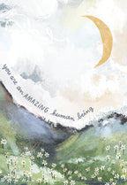 Front view of an inspiring greeting card featuring abstract artwork with a golden crescent moon, mountains, and daisies. The card reads 'you are an AMAZING human being'.