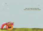 Inside of a cute Halloween greeting card with a light blue background. A small floral pumpkin and a rainbow are in the bottom left corner. The text reads: 'May your night be filled with tricks, treats, and everything sweet!' with scattered stars.