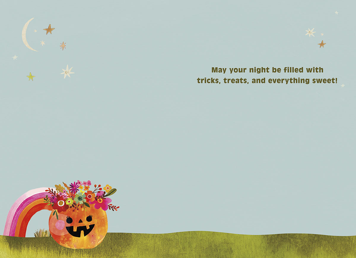 Inside of a cute Halloween greeting card with a light blue background. A small floral pumpkin and a rainbow are in the bottom left corner. The text reads: 'May your night be filled with tricks, treats, and everything sweet!' with scattered stars.