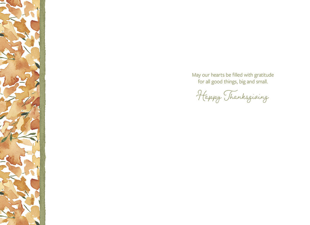 Inside view of a heartfelt greeting card, showing a blank white space for a personalized message, bordered on the left with a watercolor fall foliage pattern. The right side features a printed message in elegant script: 'May our hearts be filled with gratitude for all good things, big and small. Happy Thanksgiving.'