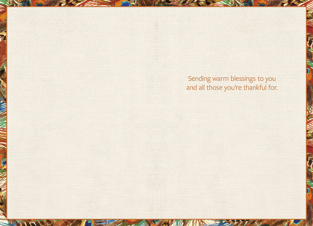 Inside of a warm autumn blessing card with a feather border, displaying the heartfelt message 'Sending warm blessings to you and all those you're thankful for' on a cream textured background.
