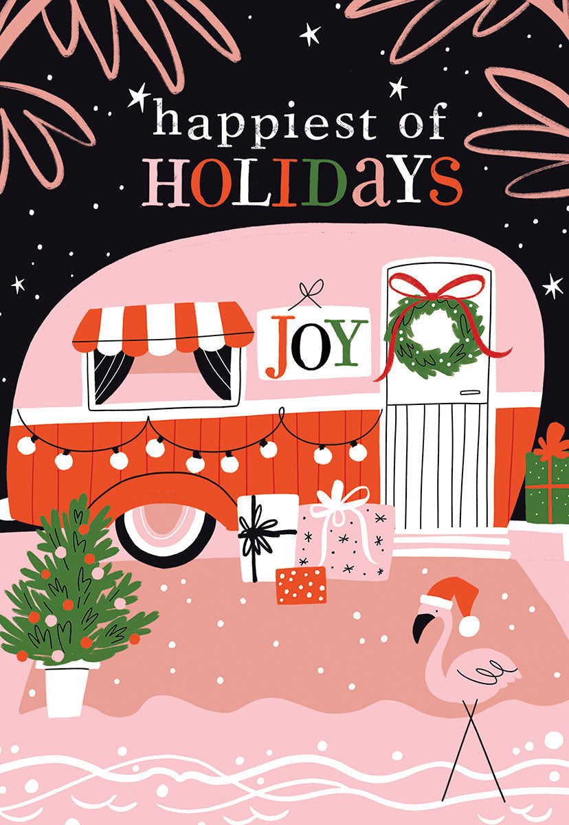 Front of a lighthearted holiday greeting card featuring a pink retro camper decorated with string lights, gifts, and a wreath. A cheerful flamingo wearing a Santa hat stands next to a mini Christmas tree. Text reads 'happiest of HOLIDAYS' against a dark, starry background. Unique holiday card design.