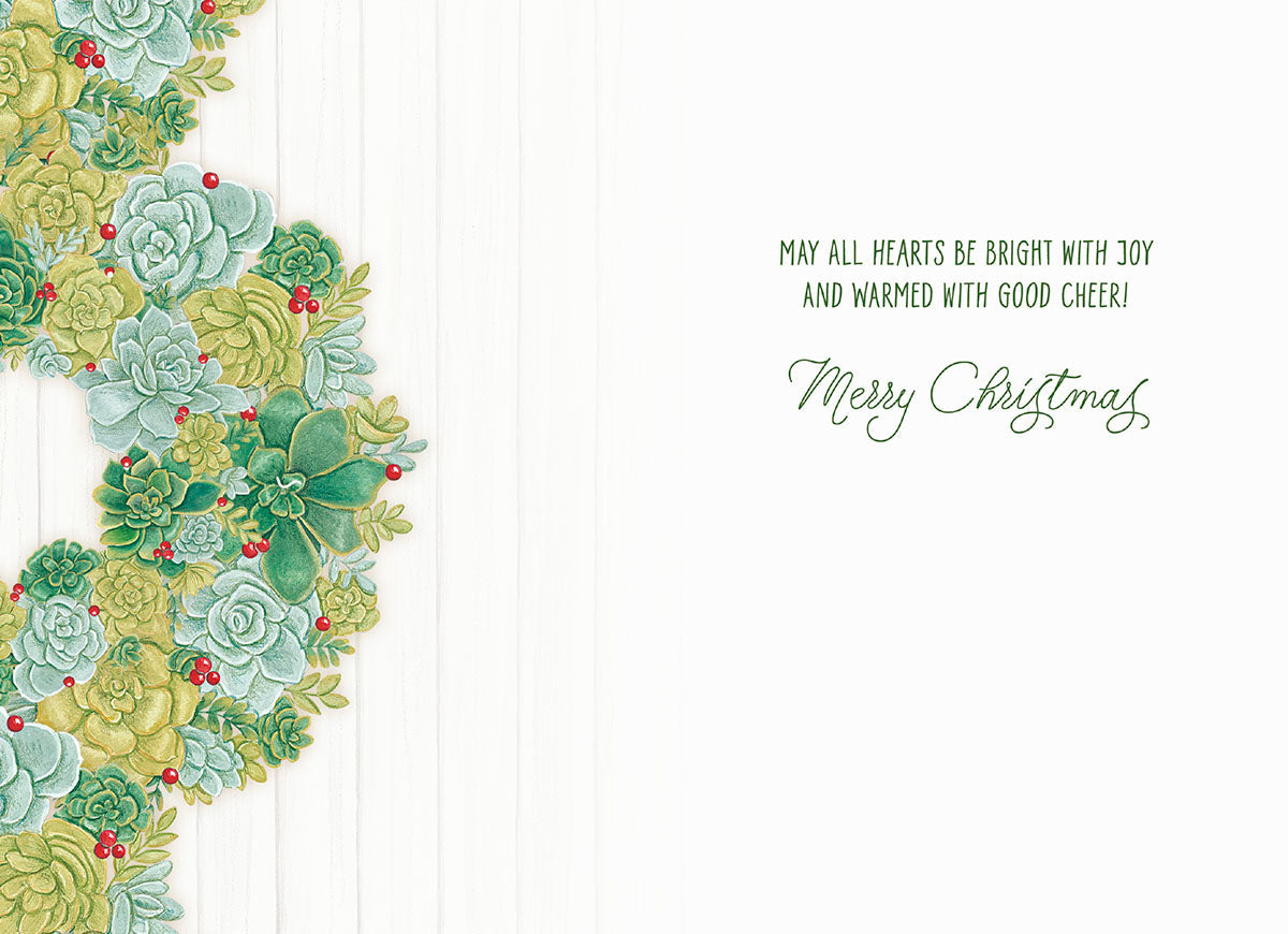 Inside of a holiday card with a partial succulent wreath design, "May all hearts be bright with joy and warmed with good cheer! Merry Christmas".