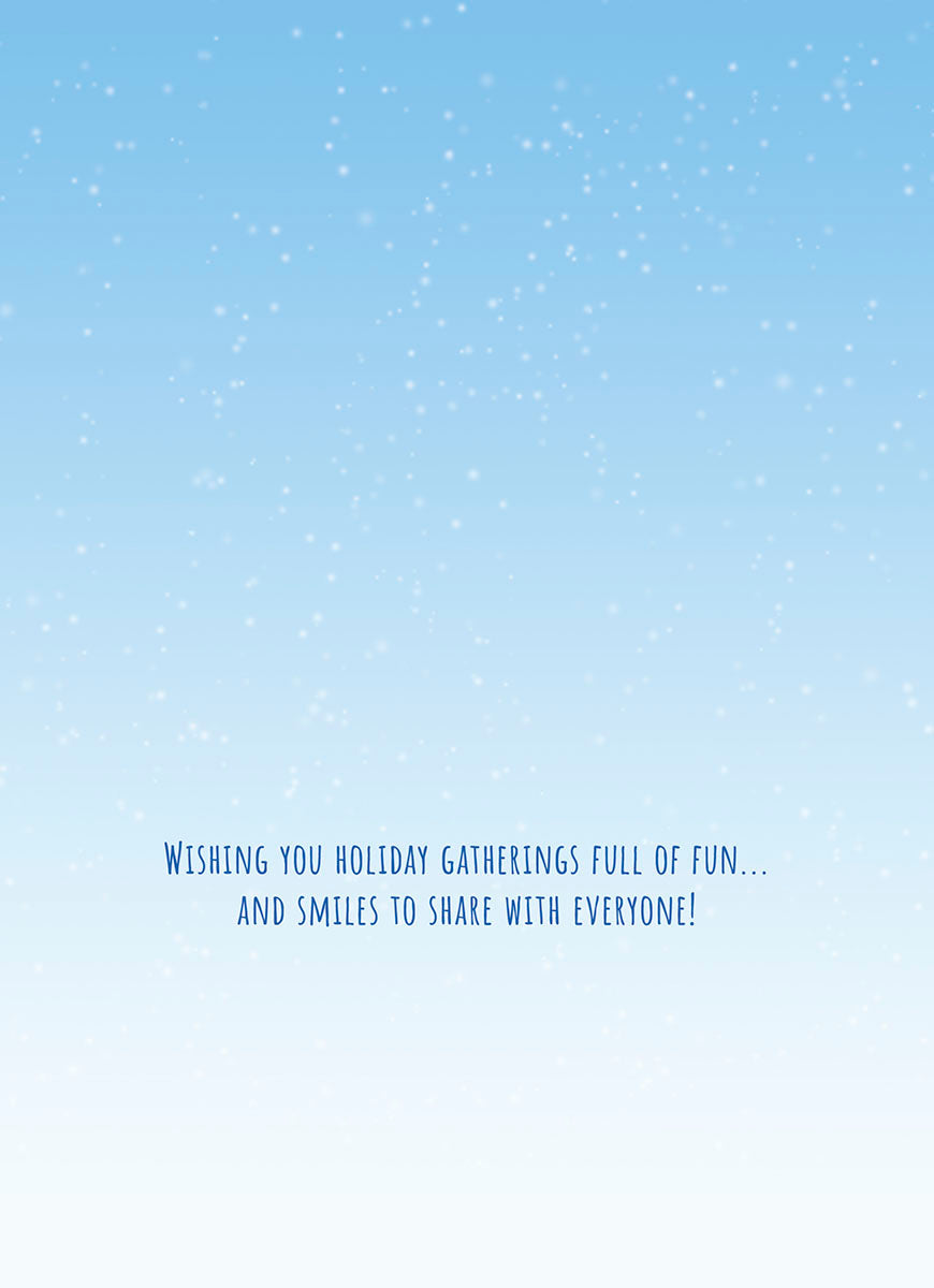 Inside of a holiday greeting card with a light blue background and white snow dots, featuring the text 'Wishing you holiday gatherings full of fun... AND SMILES TO SHARE WITH EVERYONE!' in blue script.