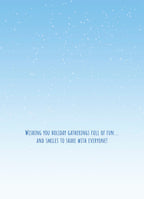 Inside of a holiday greeting card with a light blue background and white snow dots, featuring the text 'Wishing you holiday gatherings full of fun... AND SMILES TO SHARE WITH EVERYONE!' in blue script.