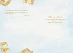 Inside view of a religious greeting card featuring a watercolor light blue background with golden ribbons, displaying Luke 2:10 scripture and the heartfelt message: 'Rejoicing with you in the bright, shining, good news of Christmas!'
