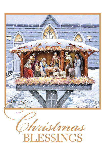 Front of a religious Christmas card with a snow-covered outdoor nativity scene and 'Christmas Blessings' text in golden script.