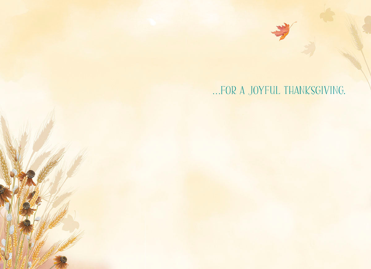 Inside of a greeting card with a soft yellow background, subtle wheat, and falling leaves. Text reads '...FOR A JOYFUL THANKSGIVING.', leaving space for a personalized message.