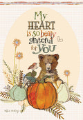 Adorable Thanksgiving greeting card featuring a cute brown bear cub peeking over an orange pumpkin and green squash, surrounded by delicate fall foliage. The card front reads 'My heart is so beary grateful for You', perfect for expressing heartfelt appreciation.