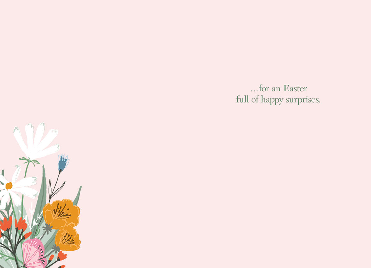 Interior of a greeting card with a small floral arrangement in the bottom left corner and the message '...for an Easter full of happy surprises.' in simple green text on a light pink background.