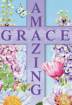 Front of a religious Easter greeting card displaying 'AMAZING GRACE' in purple text forming a cross, surrounded by vibrant watercolor spring flowers like pink tulips, purple delphiniums, and white peonies, with a delicate white butterfly against a bright blue sky.