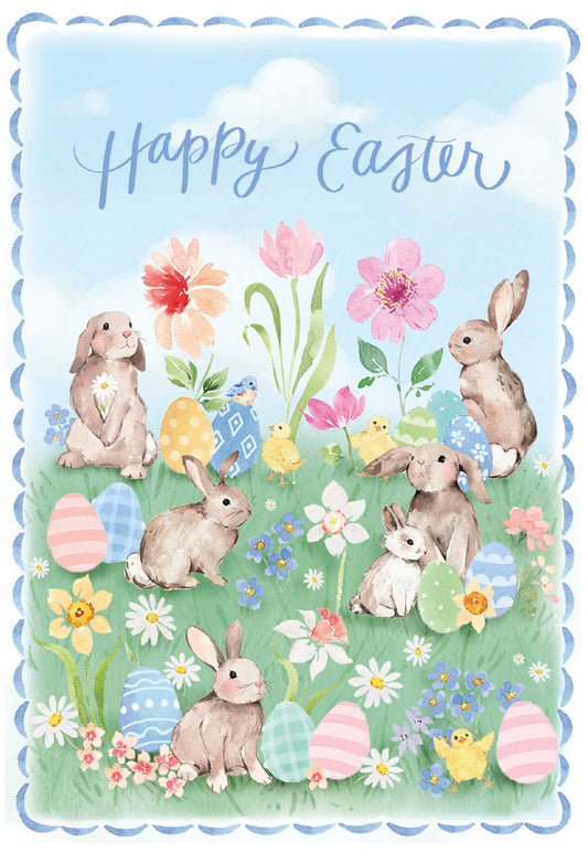 Front of a Happy Easter card with watercolor bunnies, chicks, eggs, and spring flowers in a green field under a blue sky.