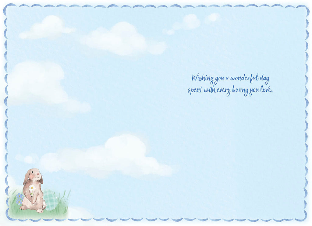 Inside view of a sweet Easter card showing a single watercolor bunny and decorated eggs in a grassy field with a light blue sky and clouds, accompanied by the message 'Wishing you a wonderful day spent with every bunny you love.'.