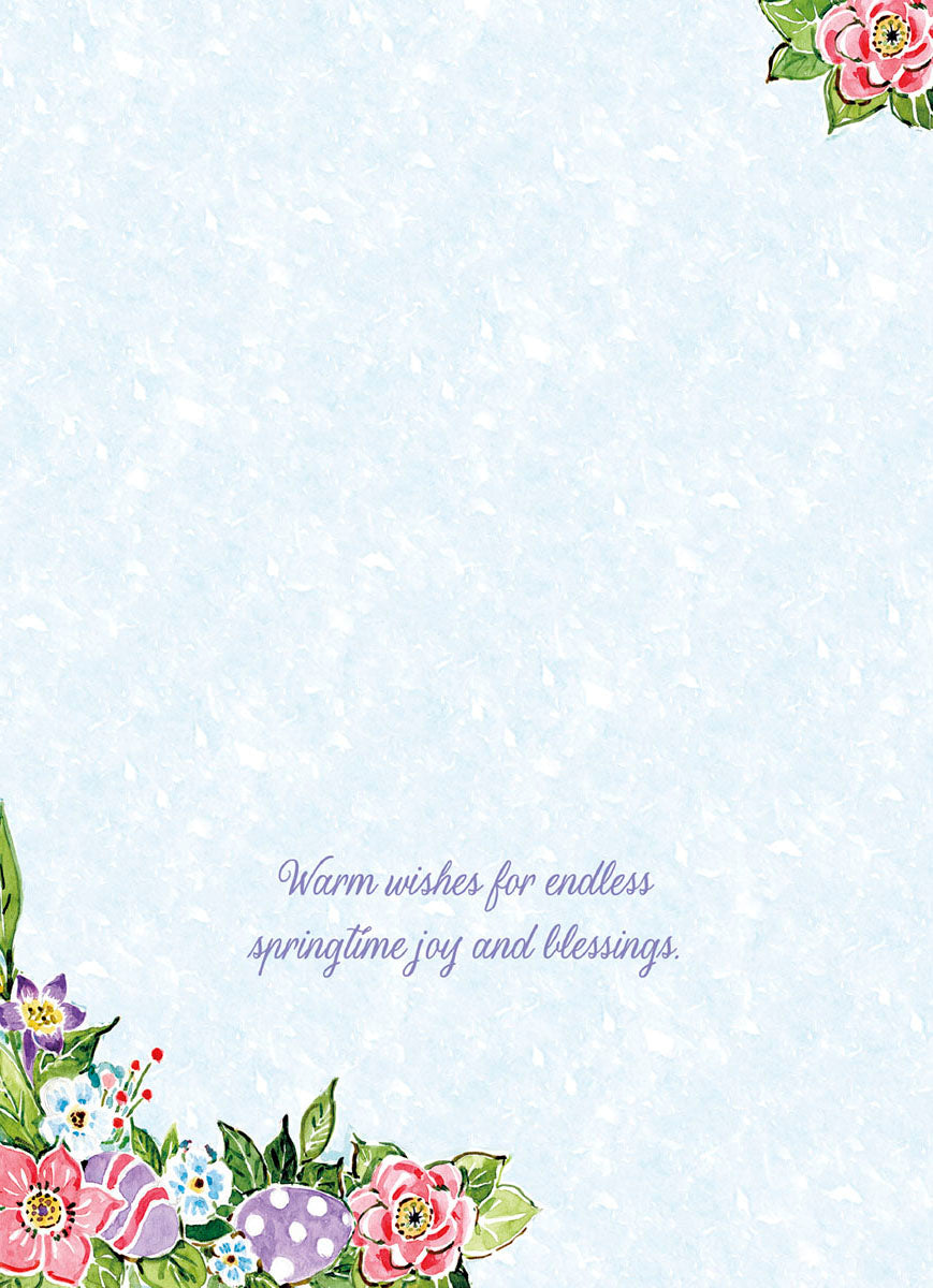 Inside view of a spring floral greeting card with a light blue textured background, decorated with watercolor flowers and eggs in the bottom left and top right corners, with the message 'Warm wishes for endless springtime joy and blessings.' in purple script.