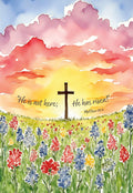 Religious greeting card featuring a watercolor sunrise with a cross silhouette, vibrant wildflowers, and Matthew 28:6 scripture for celebrating the resurrection.