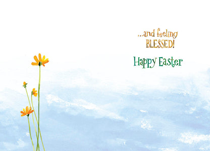 Inside of the greeting card with a simple blue sky and yellow flowers design, featuring the text "...and feeling BLESSED! Happy Easter".
