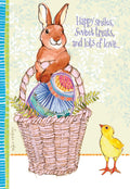 Cute watercolor spring greeting card featuring a brown bunny sitting in a pink basket with a large decorative egg, alongside a happy yellow chick. The card displays the text 'Happy smiles, Sweet treats, and lots of love...' on a light green background with subtle foliage.