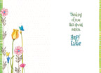Inside view of an Easter greeting card displaying colorful spring flowers along the left border, a blank space for a personal message, and the printed text 'Thinking of you this special season. Happy Easter' on the right side.
