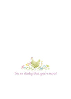 Inside view of a charming Mother's Day card, displaying a smaller watercolor illustration of a hen and chicks amidst wildflowers. The heartwarming message 'I'm so clucky that you're mine!' is prominently featured.
