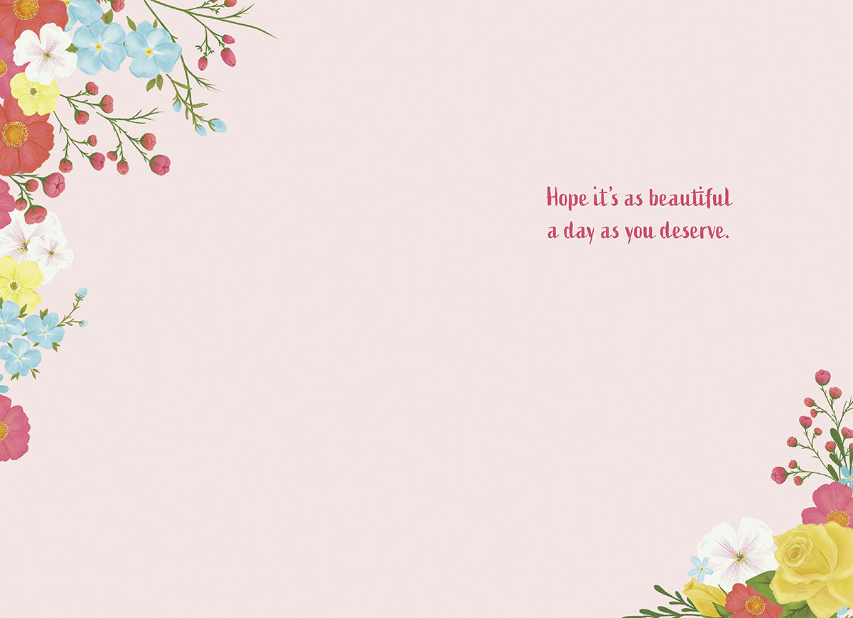 Inside of a pink greeting card with corner floral designs and the message "Hope it's as beautiful a day as you deserve."