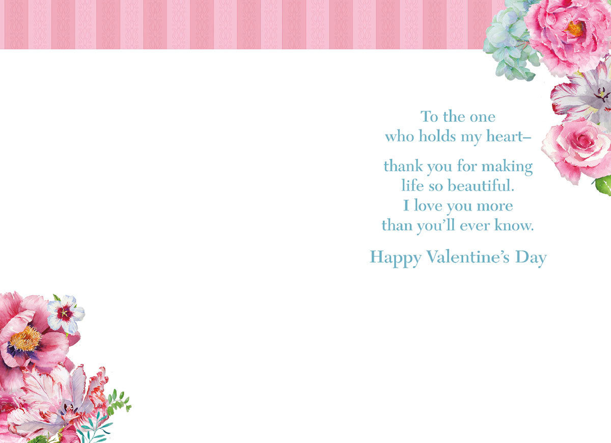 Inside of romantic greeting card for spouse, revealing heartfelt message 'To the one who holds my heart... I love you more than you'll ever know. Happy Valentine's Day' with watercolor floral accents.