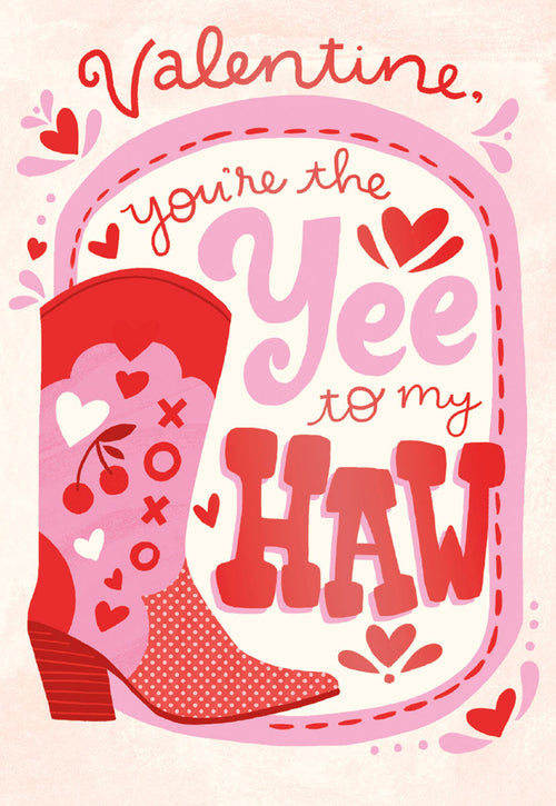 Front of a Valentine's Day greeting card featuring a pink and red cowboy boot with heart, cherry, and XOXO patterns. The card reads 'Valentine, you're the Yee to my Haw' in playful script.