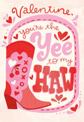 Front of a romantic Valentine's greeting card featuring a pink and red cowboy boot with heart accents and 'Valentine, you're the Yee to my Haw' text. Ideal for spouse or partner.
