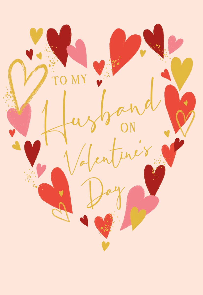 Front of a romantic greeting card for husband, featuring a heart-shaped wreath of red, gold, and pink hearts on a light pink background.