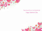 Open view of a heartfelt greeting card interior showing a white background with decorative corners of pink hearts and flowers. Reads 'Every day with you is my favorite day! Happy Valentine's Day' in fuchsia text.