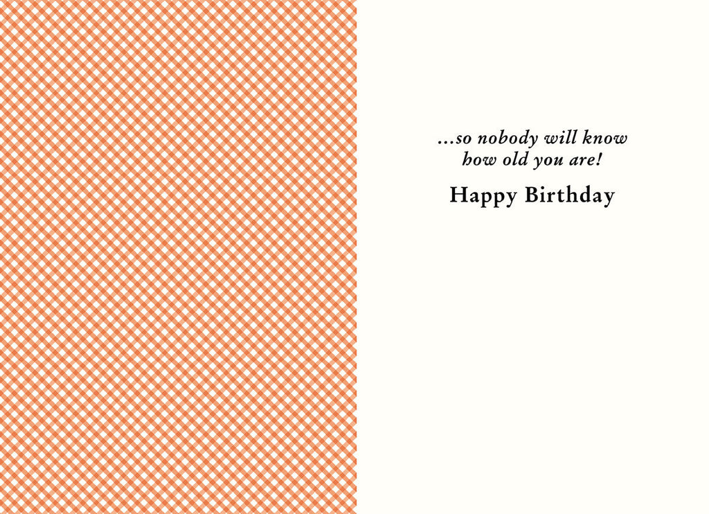 Inside of a lighthearted greeting card showing an orange gingham pattern on the left and white space on the right, revealing the humorous punchline '...so nobody will know how old you are! Happy Birthday' for a fun friend's card.