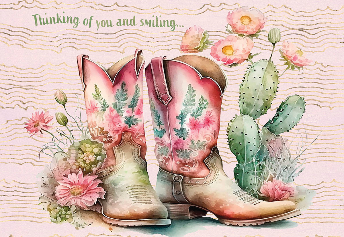 Front of a watercolor greeting card with cowgirl boots, cactus, pink flowers, and 'Thinking of you and smiling...' text.