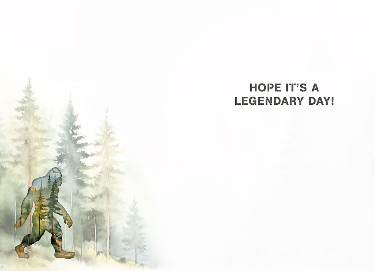 Inside of a Bigfoot themed greeting card showing a forest-filled Bigfoot illustration on left and 'HOPE IT'S A LEGENDARY DAY!' text on right.