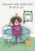 Funny greeting card front showing an older woman in a party hat and sunglasses holding a teacup, with two cats also in party hats. Text reads 'BIRTHDAYS HAVE NEVER BEEN MY CUP OF TEA.'
