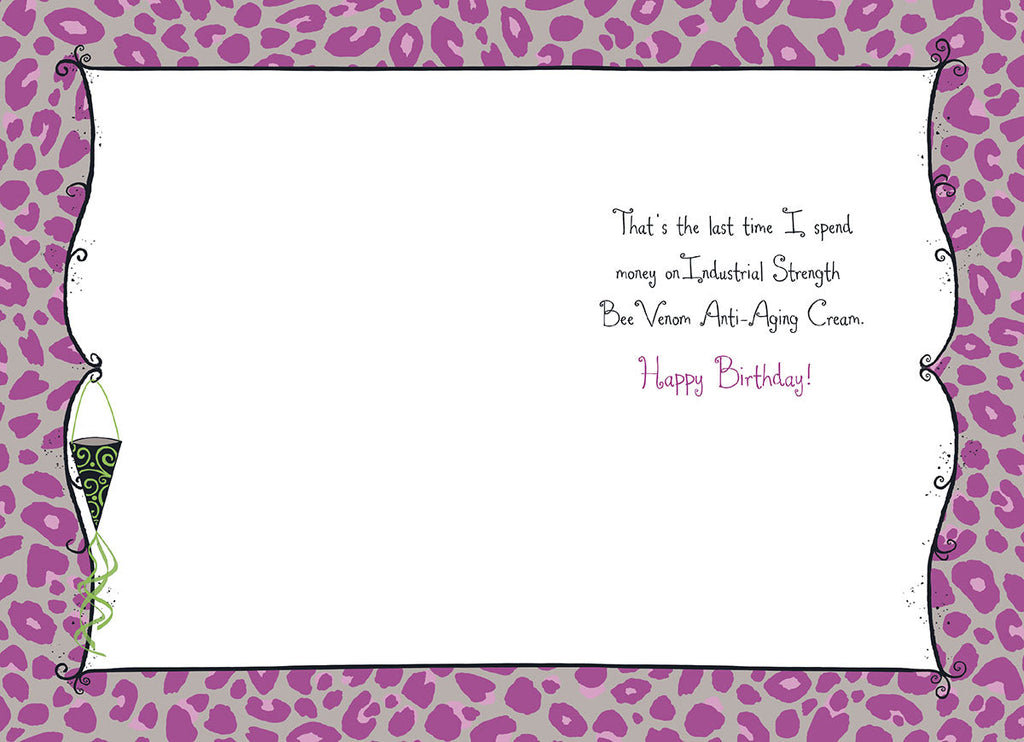 Inside of a humorous birthday greeting card, revealing the witty punchline 'That's the last time I spend money on Industrial Strength Bee Venom Anti-Aging Cream. Happy Birthday!' against a playful purple leopard print border.