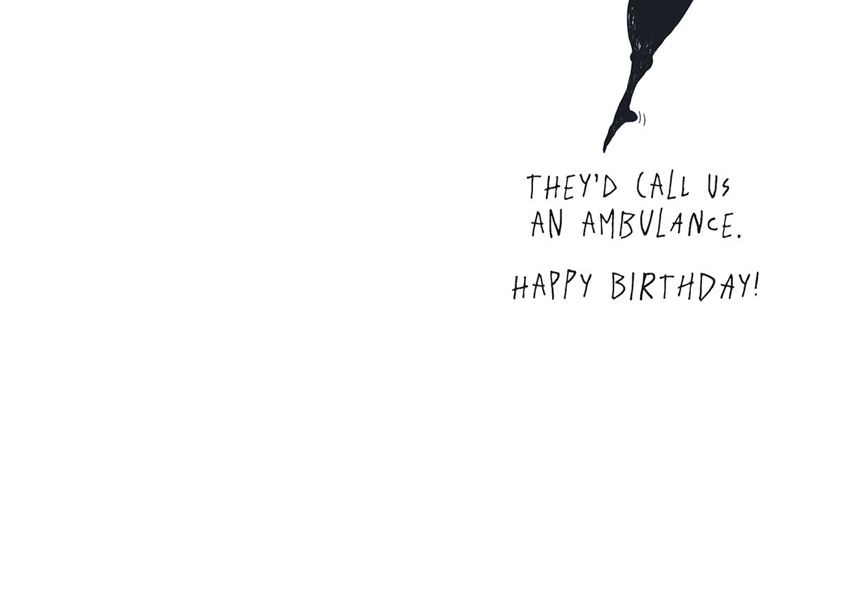 Inside view of a humorous birthday card showing the punchline text: 'THEY'D CALL US AN AMBULANCE. HAPPY BIRTHDAY!' on a white background, completing the joke about the woman's pole dance attempt.