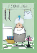 Funny greeting card front for grandma or an older woman, featuring a cartoon illustration of a grey-haired woman in a party hat holding laundry in a utility room, with a black cat. Perfect for a milestone celebration.