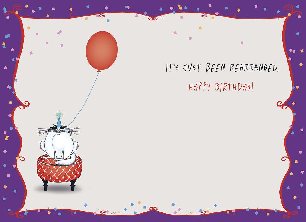 Inside of a funny occasion card showing a grumpy cat in a party hat with a red balloon, and text "It's Just Been Rearranged. Happy Birthday!"