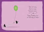 Inside of a funny greeting card on a light purple background. A single green balloon is tied to a small barbell lying on the floor. Witty text reads 'Hard of hearing... Hard of seeing... Hardened arteries... Happy Birthday from one hard-body to another!'