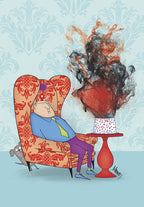Humorous greeting card showing a man wearing a party hat, looking overwhelmed as a cake on a red table erupts in smoke and confetti next to his armchair, with a dog peeking out.
