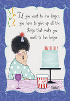 Front of a funny birthday greeting card featuring a cartoon woman with curly hair, wearing a party hat and glasses. She's sitting at a table with a slice of blue cake, a tub of ice cream, and a glass of wine. The text reads: 'If you want to live longer, you have to give up all the things that make you want to live longer.' The background is a decorative blue swirl pattern, perfect for an adult birthday.