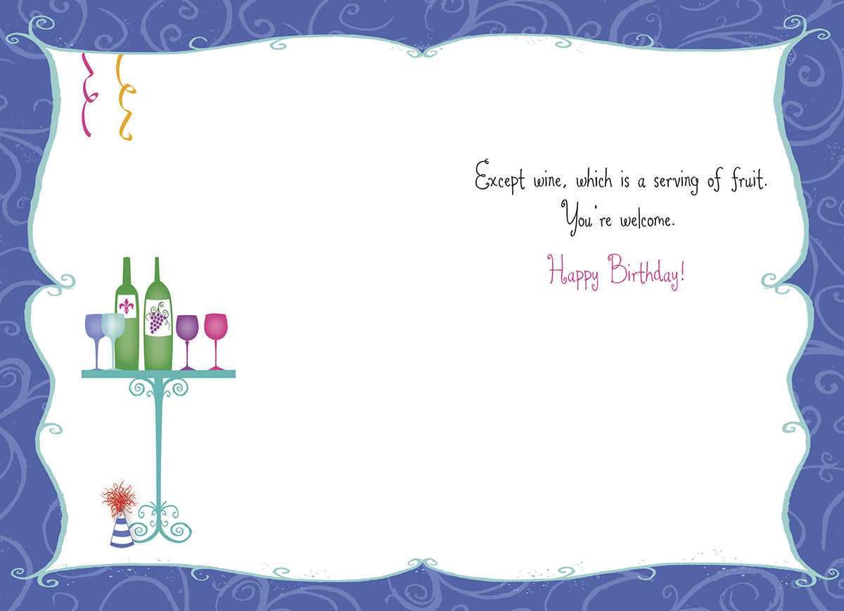Inside view of a humorous birthday card. The message continues the joke from the front, stating: 'Except wine, which is a serving of fruit. You're welcome. Happy Birthday!' On the left, there's a small illustration of two wine bottles and three wine glasses. The card's border matches the blue swirl pattern from the front.