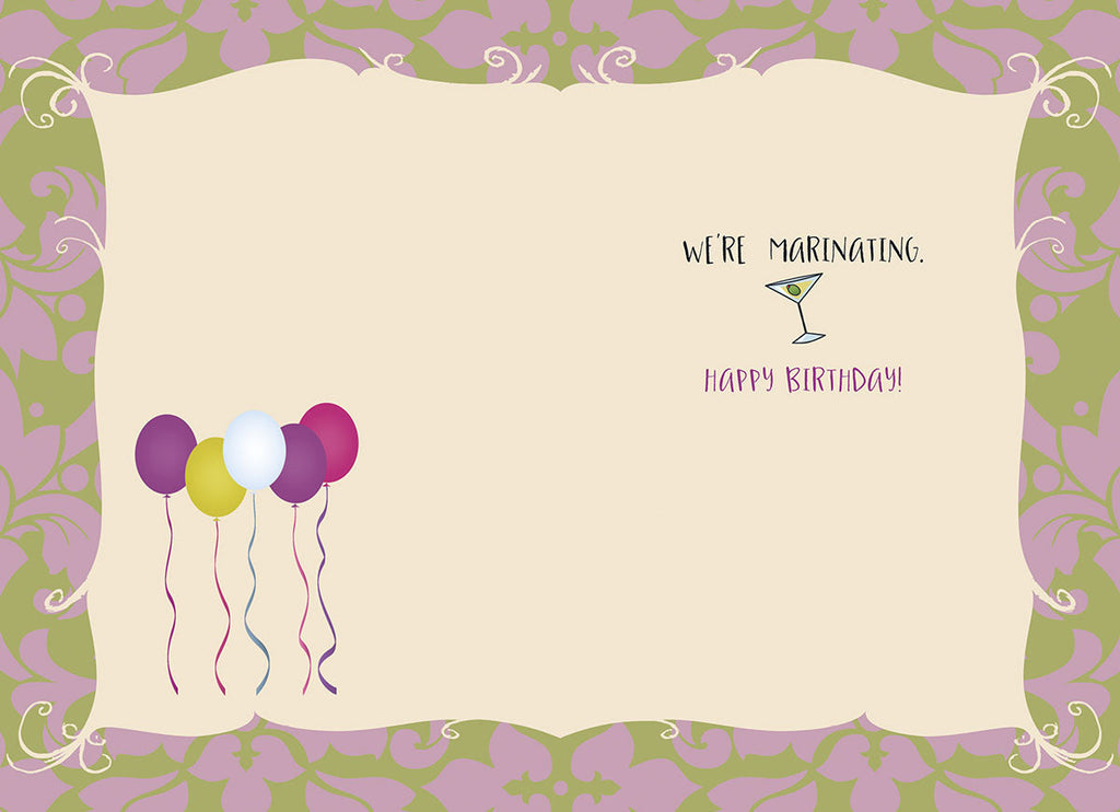 Inside of funny birthday card showing four colorful balloons (purple, yellow, white, pink) and a martini glass with text: 'WE'RE MARINATING. HAPPY BIRTHDAY!'