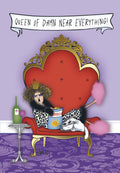 Humorous greeting card featuring a sassy woman in a crown and leopard print robe, relaxing on a red and gold throne with chips, wine, and a white cat. Text reads 'QUEEN OF DAMN NEAR EVERYTHING!'. Perfect for a fun female pal.