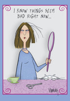 Funny encouragement greeting card showing a cartoon woman with messy, self-cut hair looking in a mirror, a cat peeking, and text 'I KNOW THINGS SEEM BAD RIGHT NOW...'. Perfect for a friend needing a laugh and support.