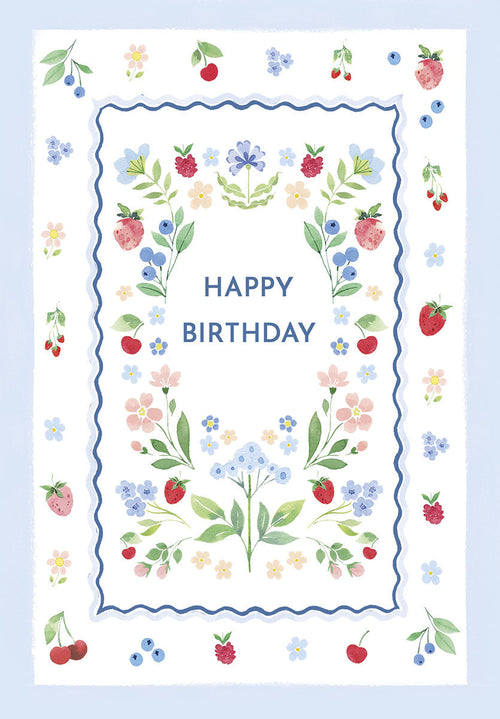 Front view of a charming watercolor birthday card featuring a central blue wavy frame. The frame is adorned with a delicate wreath of hand-painted strawberries, blueberries, cherries, and small pastel pink and blue flowers, with 'HAPPY BIRTHDAY' elegantly centered inside. The card has a light blue border and white background.