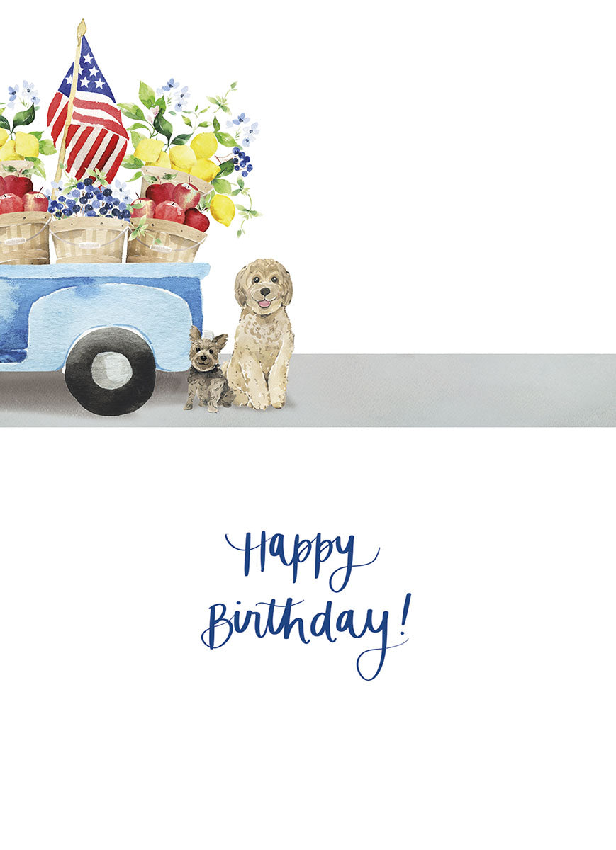 Inside of a cute greeting card showing a golden doodle and yorkie sitting next to a blue watercolor pickup truck, with 'Happy Birthday!' in elegant script.