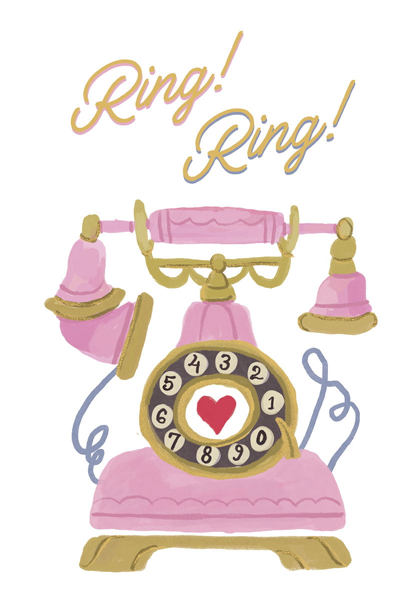 Front of a lighthearted greeting card featuring a pink vintage rotary telephone with gold accents and the words 'Ring! Ring!' in playful script. A red heart is centered on the phone dial.
