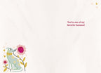 Inside view of a friendship greeting card with a cute blue dog and pink flower illustration, displaying the warm message 'You're one of my favorite humans!'.