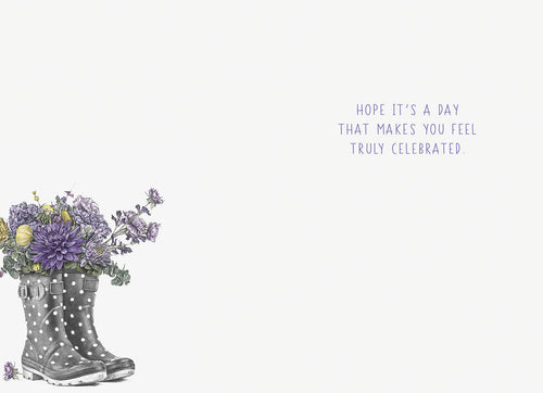 Inside of a thoughtful greeting card displaying a partial view of floral-filled wellington boots and the heartfelt message 'HOPE IT'S A DAY THAT MAKES YOU FEEL TRULY CELEBRATED.'