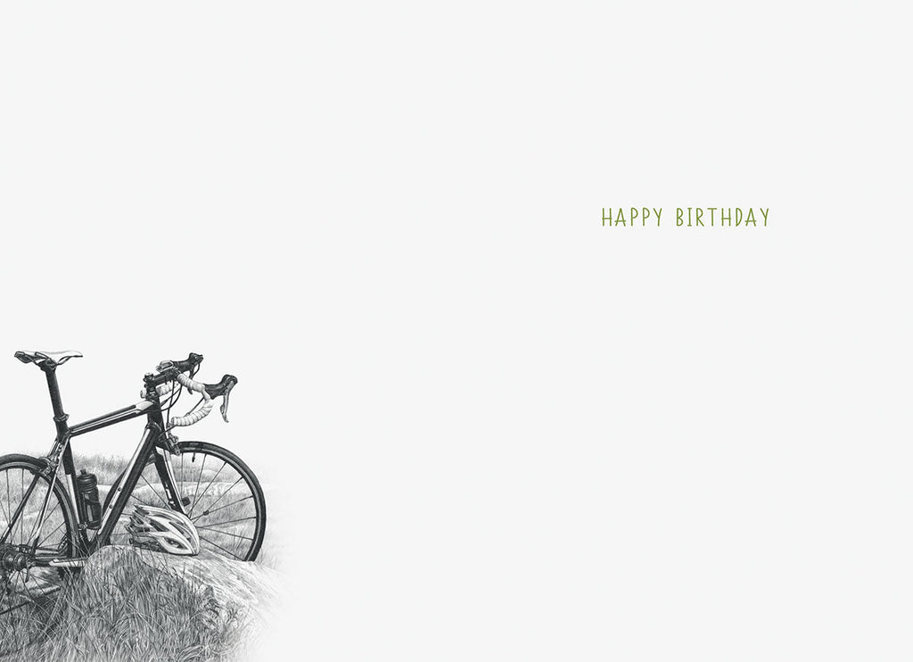 Inside of an encouraging greeting card, showing a faint illustration of a bicycle in the lower left corner and 'HAPPY BIRTHDAY' text in green on the right, on a light grey background.